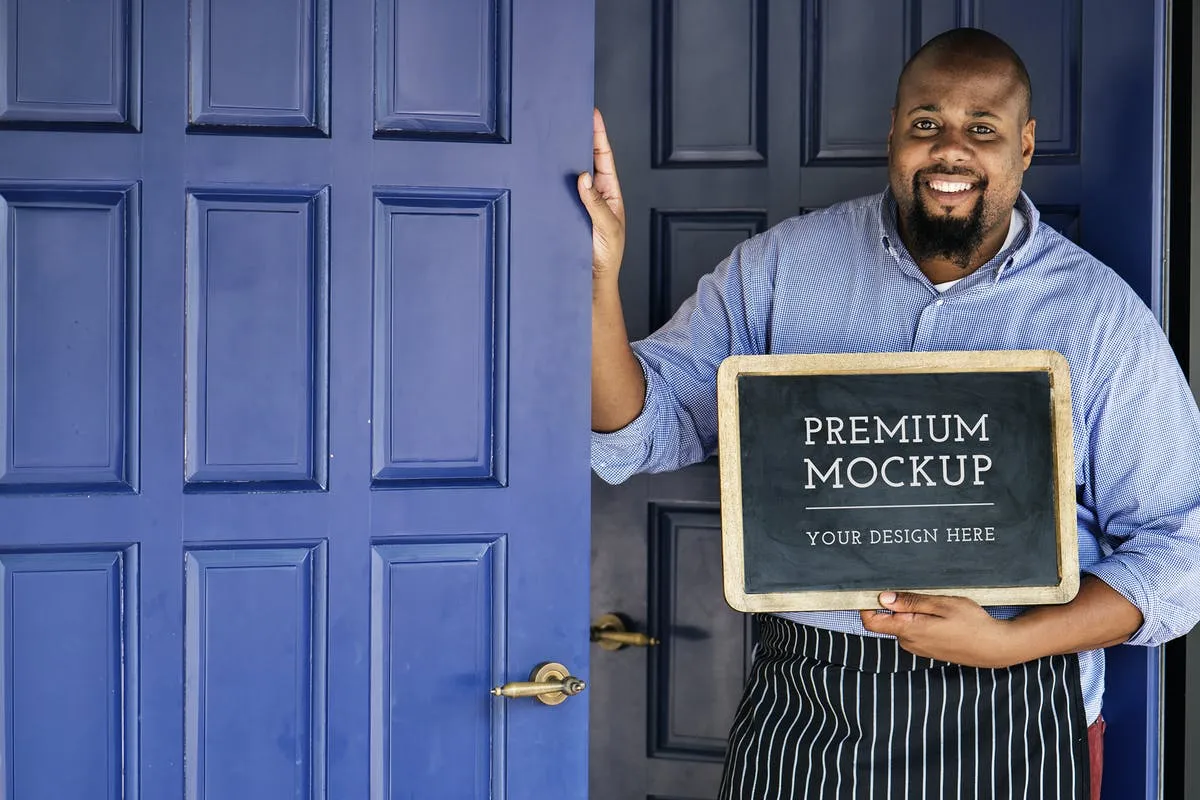 实木材质黑板框架真人演示样机素材 Man holding Open Sign Mockup